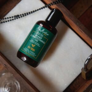 Beard conditioning oil bottle on a rustic wooden tray with a lock and chain, top view.